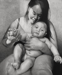 a black and white drawing of a woman holding a baby